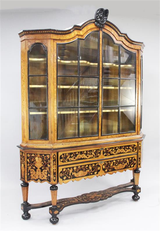 A 19th century Dutch marquetry inlaid bookcase, W.5ft 7in. H.7ft 6in.